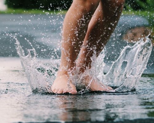 VenaVine - closeup of the person s feet jumping in the puddle 2022 12 20 16 55 32 utc 1Cold Weather Related Leg AilmentsUncategorized